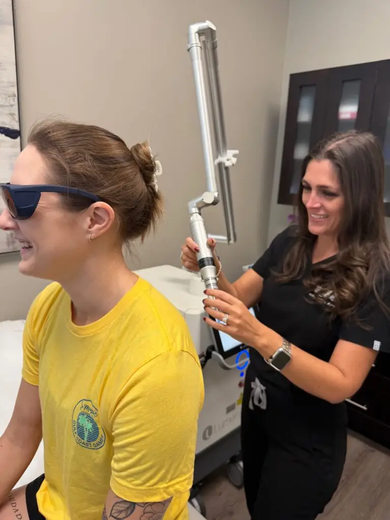 Smiling patient and provider before laser tattoo removal session at EradiTatt