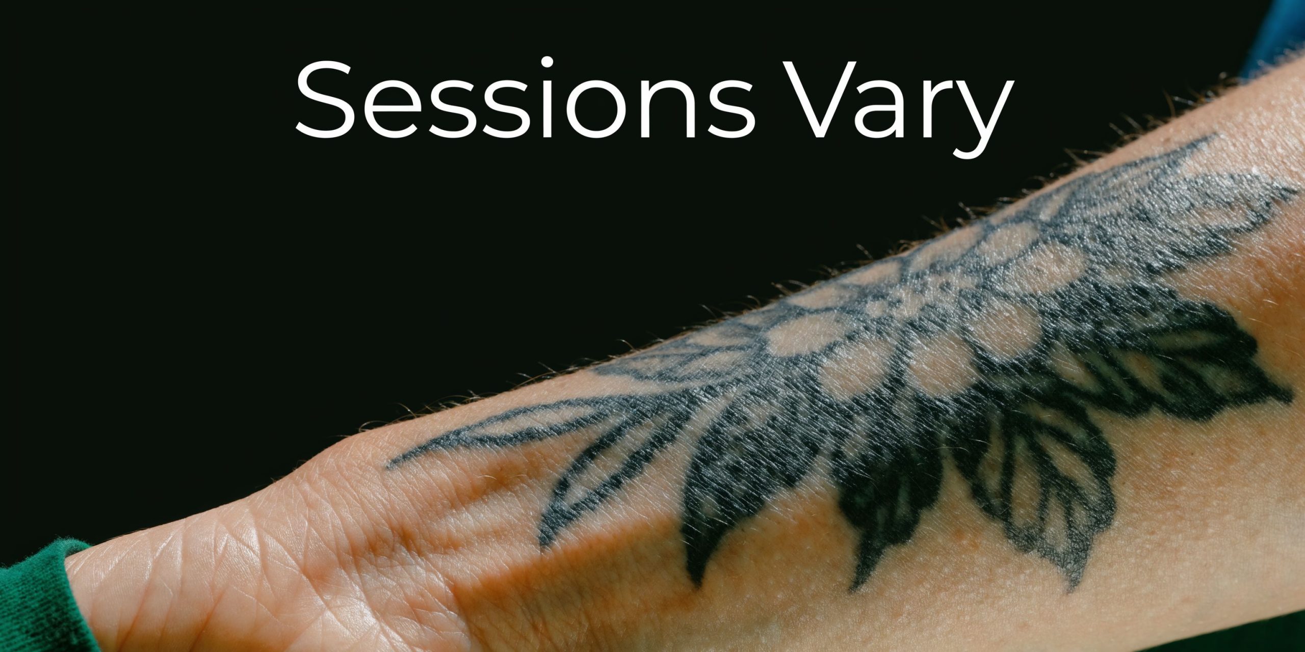 A close-up view of a person's tattooed forearm, highlighting the need for varying tattoo removal sessions.