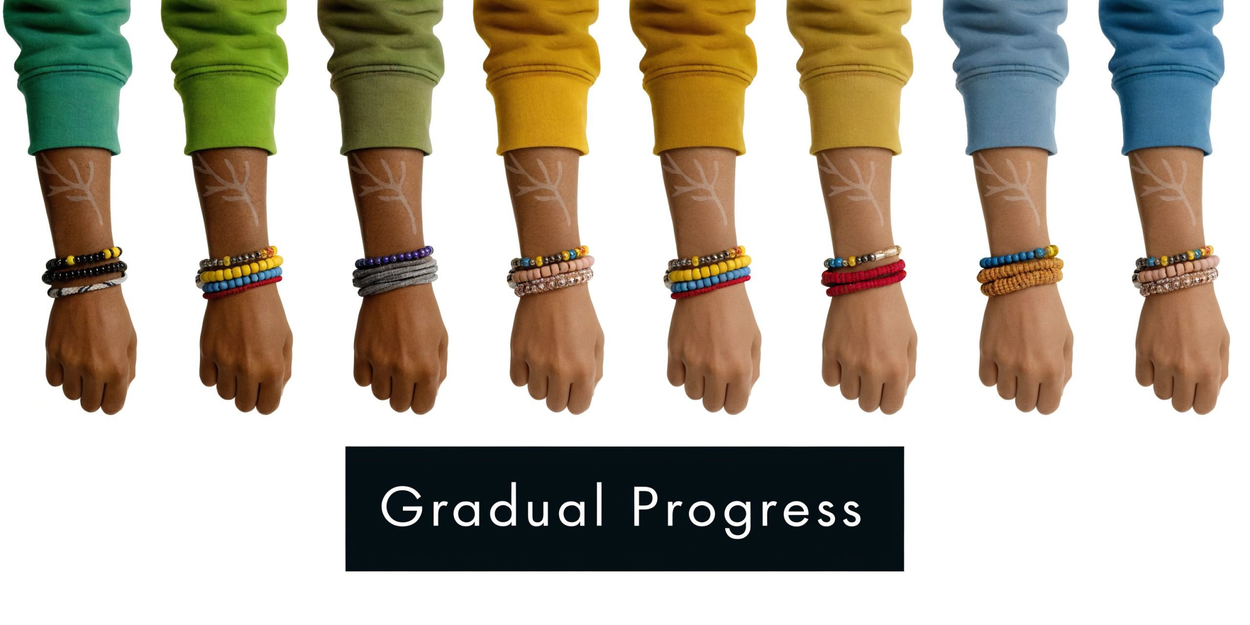 A row of eight dark-skinned forearms with gradual tattoo removal progress displayed on the skin.