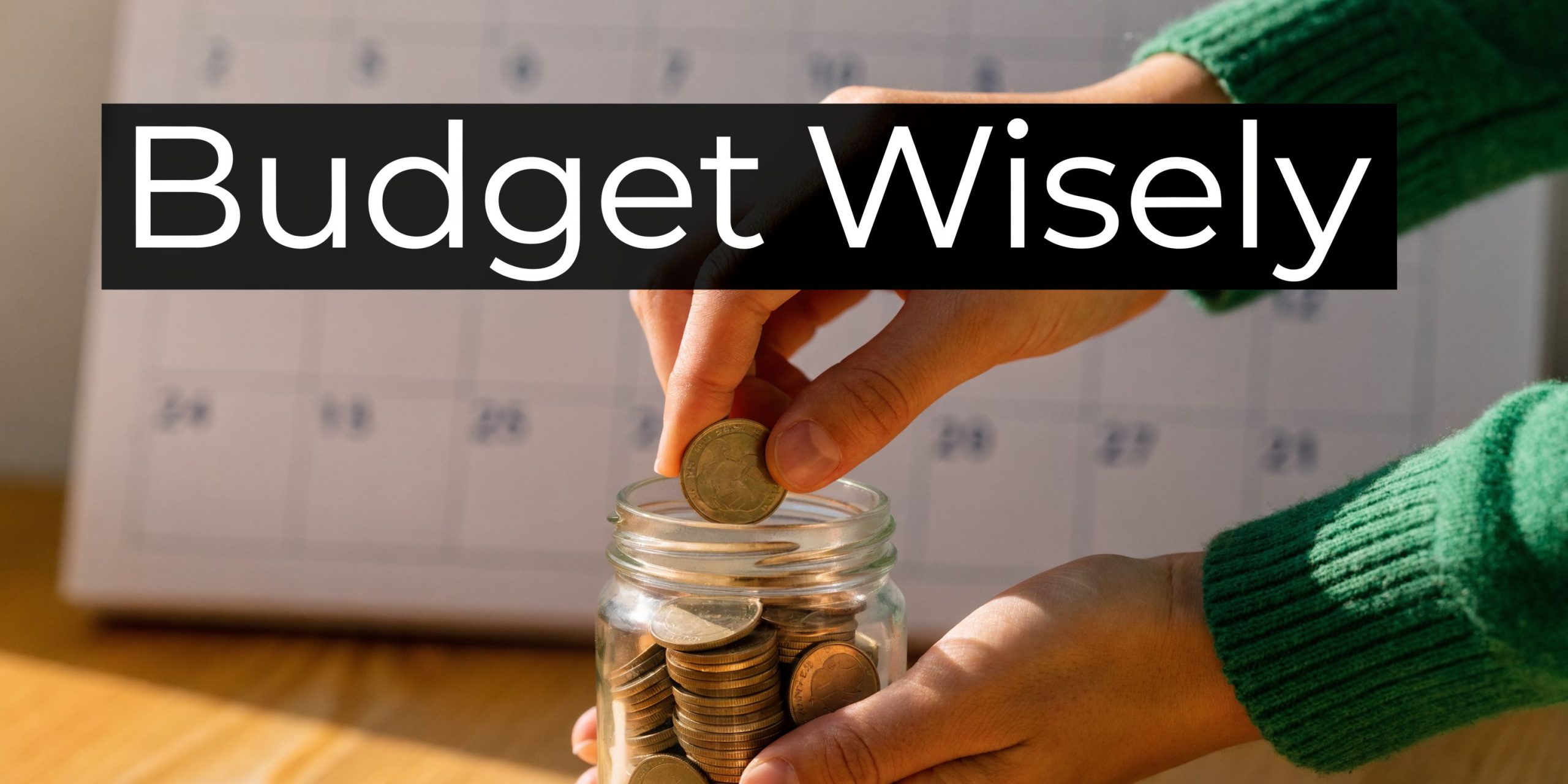 A person in a green sweater puts a gold coin into a glass jar filled with coins.