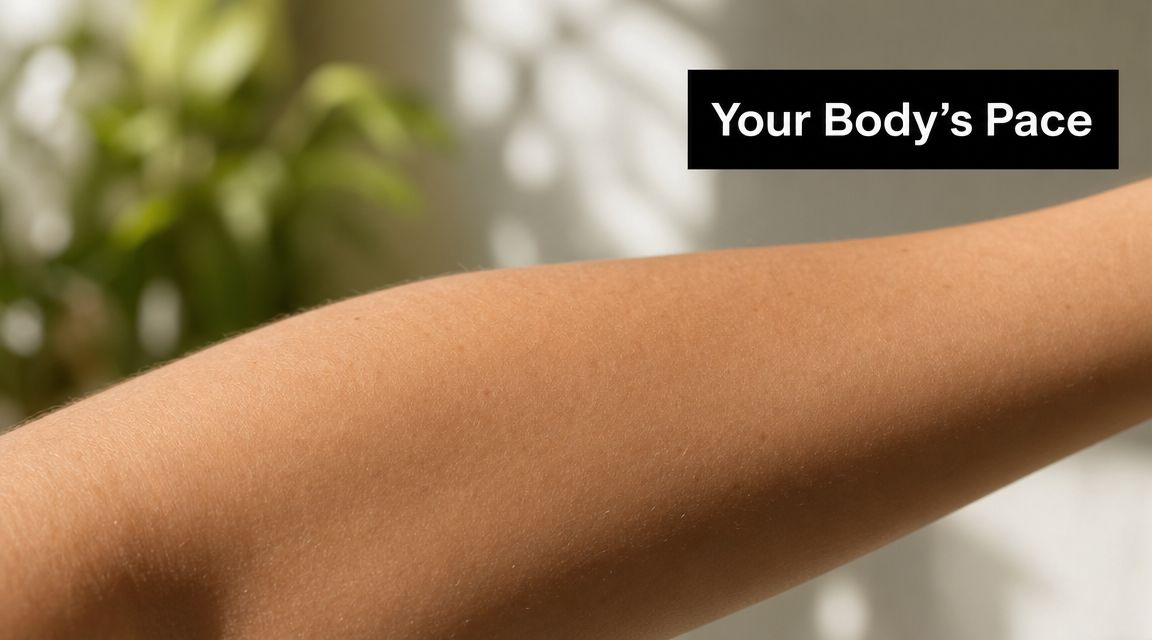 A close-up view of a person's smooth, tanned skin on their arm with natural lighting.